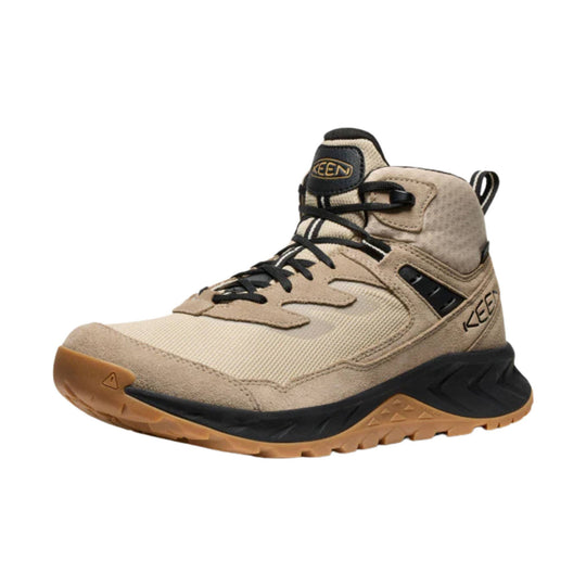 Beige and black mid-top hiking boot with bungee laces and a gum outsole