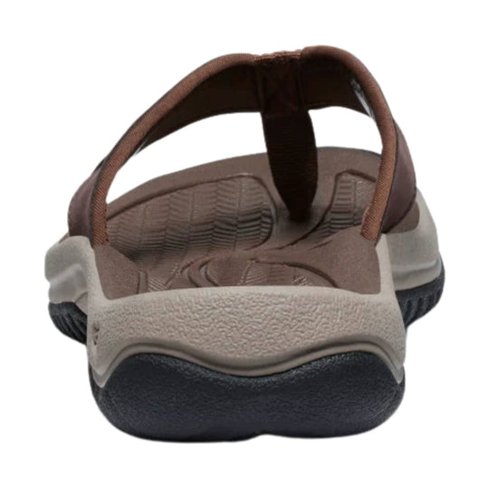 Brown and beige open-back sandal with a thick black sole and adjustable heel strap