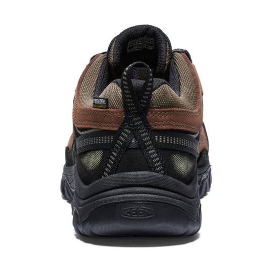 Black and brown hiking shoe seen from the back with bungee laces and a thick rugged sole.