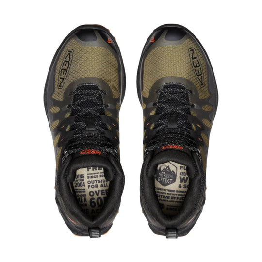Pair of olive and black hiking boots with black laces and orange accents, top view