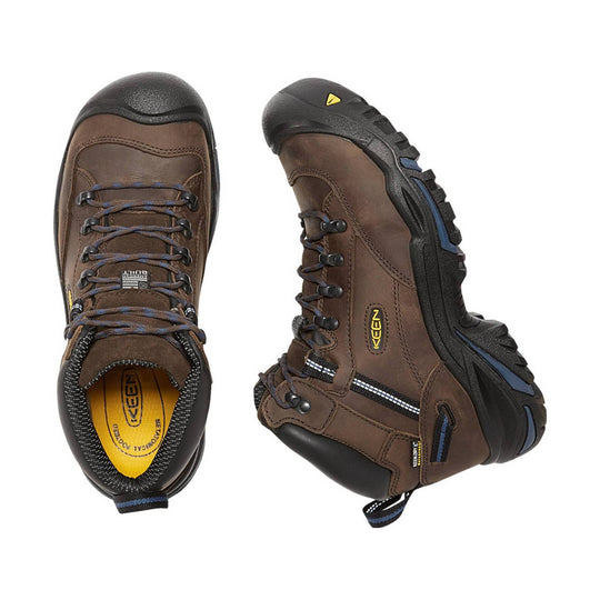 Pair of brown hiking boots with black soles on a white background