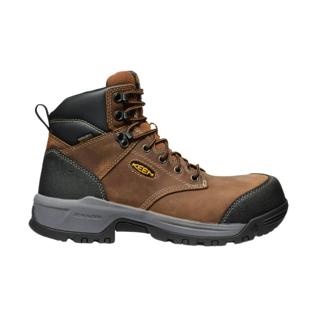 Brown and black lace-up work boot with a gray sole and black toe cap, side view