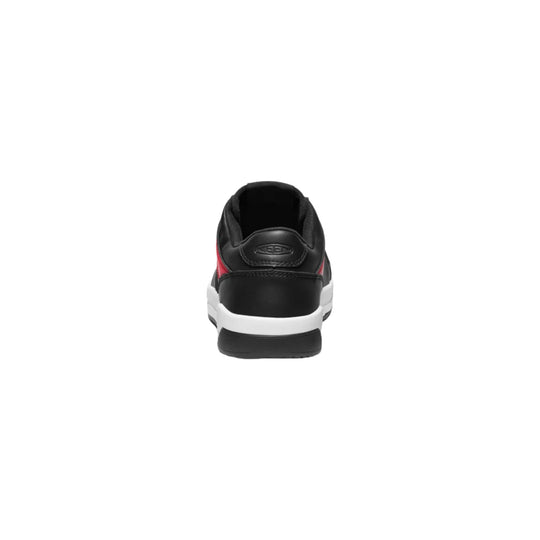 Black work shoe with a white sole and red side accents, shown from the back.