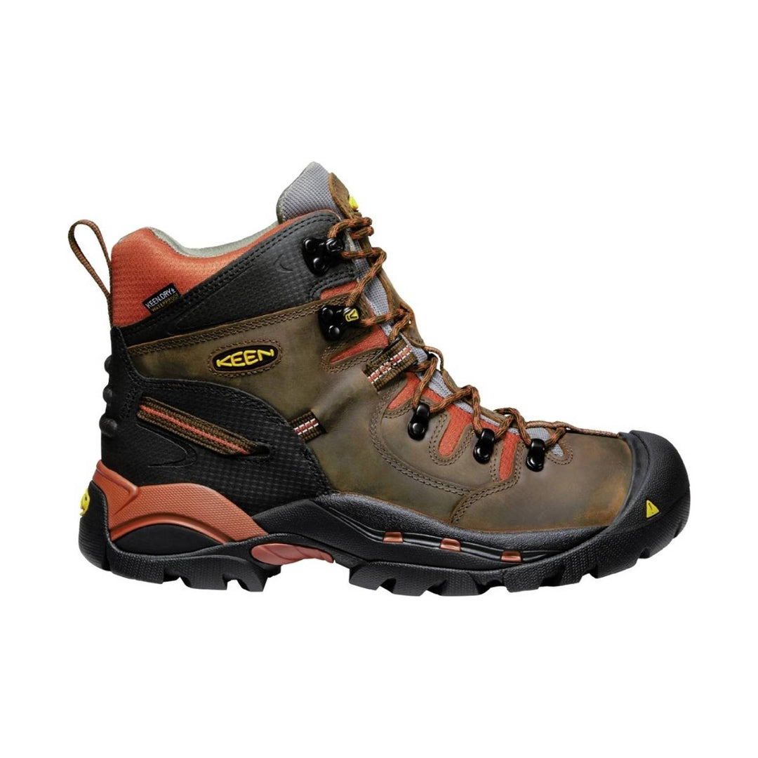 Brown hiking boot with orange accents on a white background