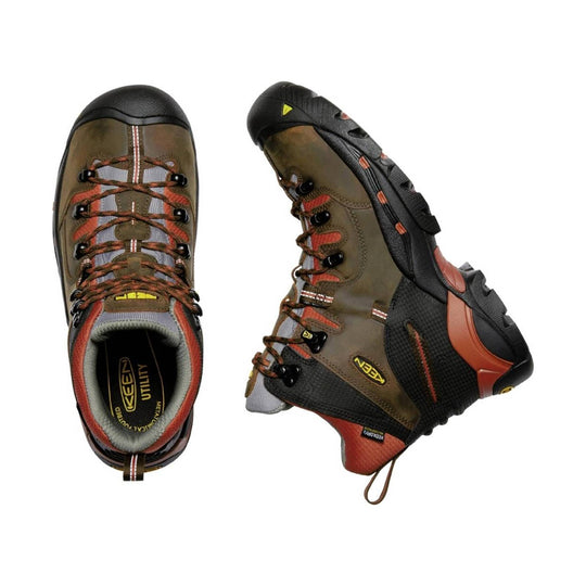 Pair of hiking boots with brown and black color scheme on a white background