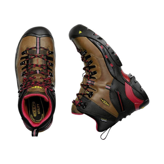 Pair of brown and black hiking boots with red accents on a white background