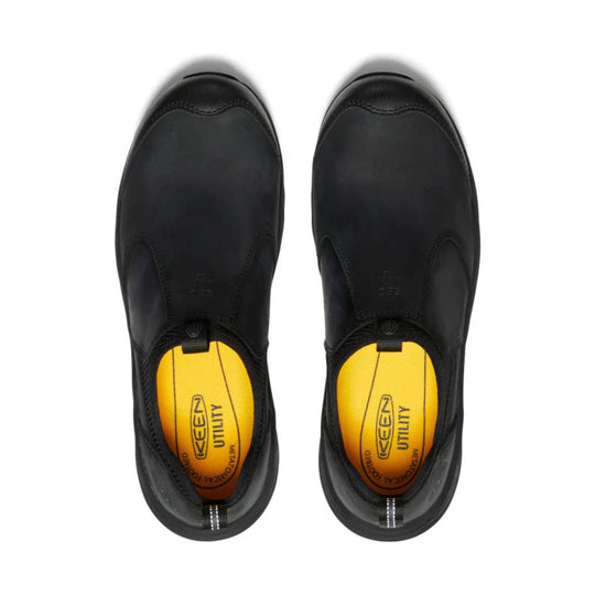 Black slip-on work shoes shown from above with yellow insoles