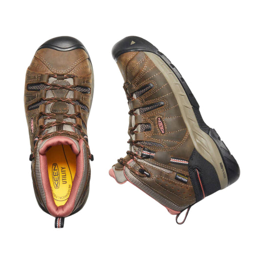 Brown mid-height hiking boot with black rubber toe cap, pink lining, and visible laces, shown from top and side views.