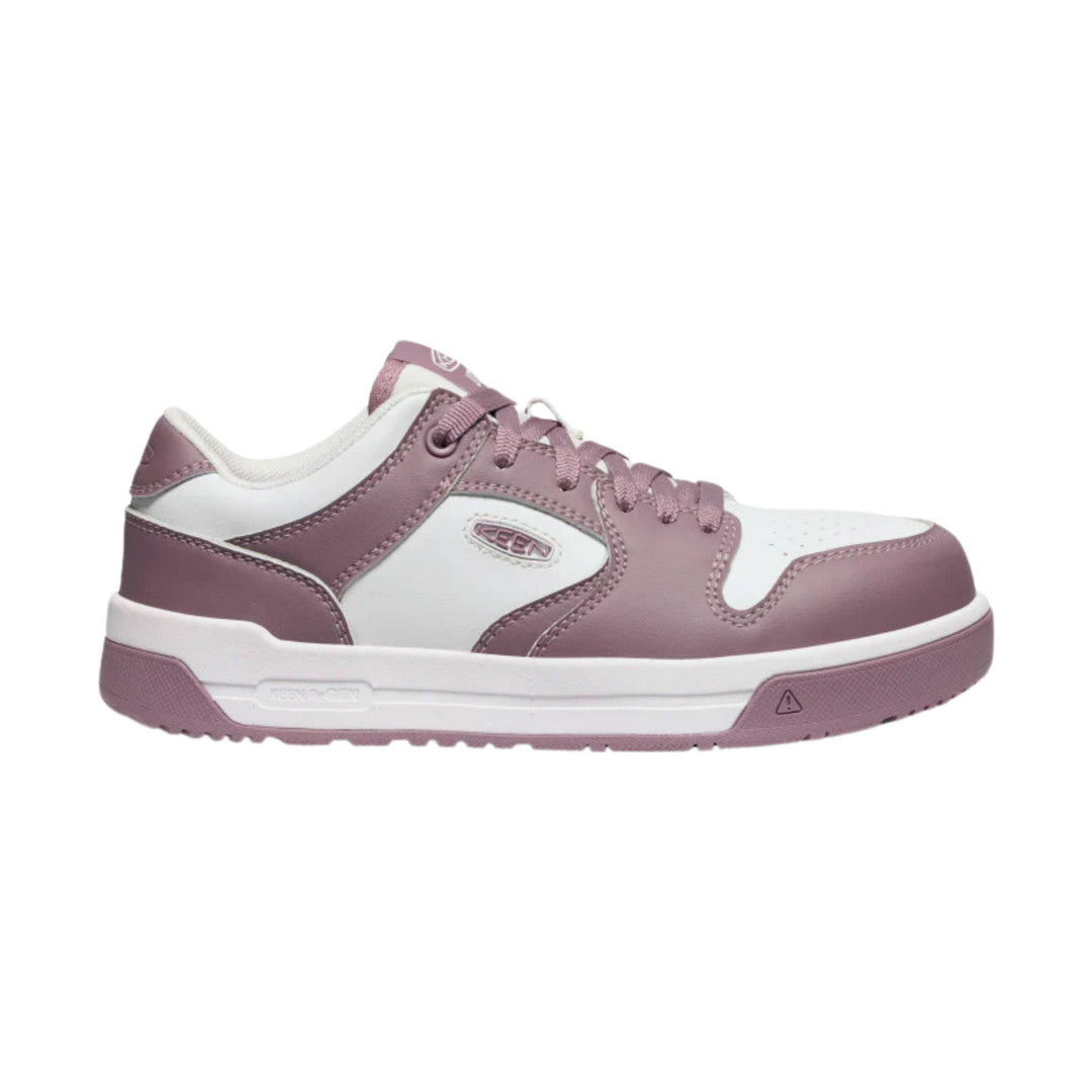 Pink and white low-top work shoe with laces and a side logo