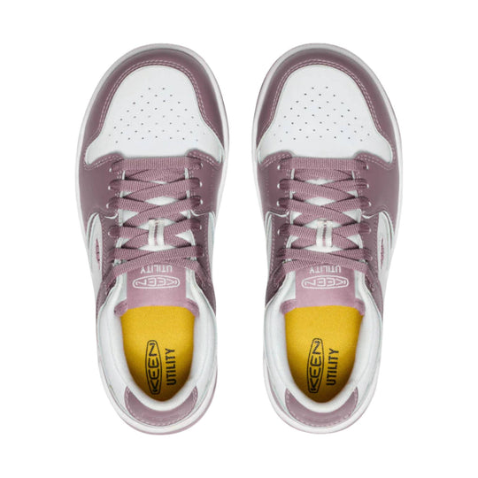 Pair of white and mauve low-top work shoes with laces and yellow insoles, top view