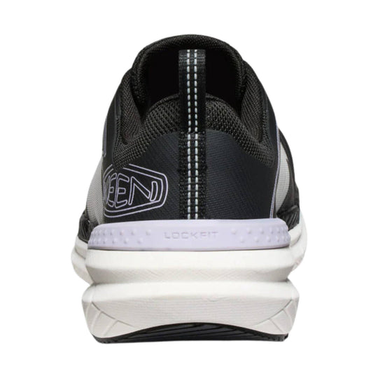 Black and white athletic work shoe seen from the back with a white cushioned heel and side logo