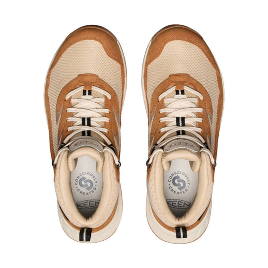 Pair of tan and brown hiking boots with white laces, viewed from above