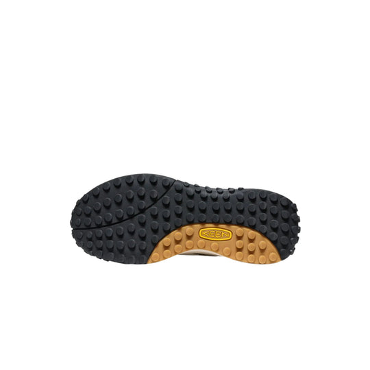 Black and tan sneaker outsole with raised traction lugs and KEEN logo