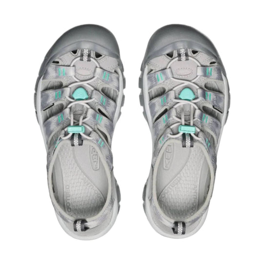 Pair of gray closed-toe hiking sandals with bungee laces and turquoise accents, viewed from above