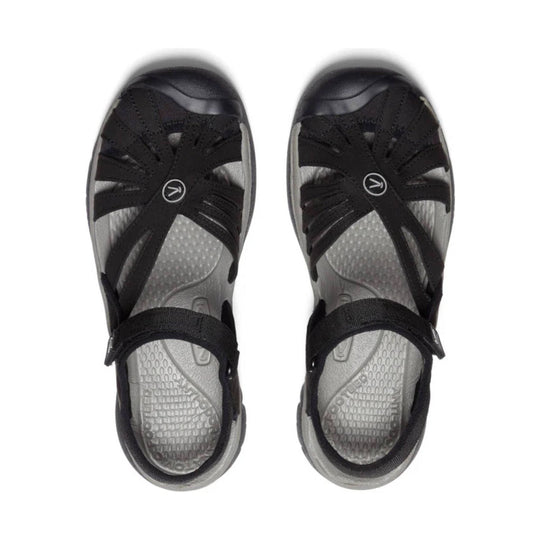 Pair of black and gray closed-toe sandals with bungee straps and open side cutouts, top view
