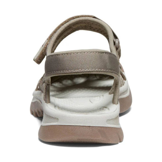 Rear view of a beige and taupe closed-toe sandal with a padded heel strap