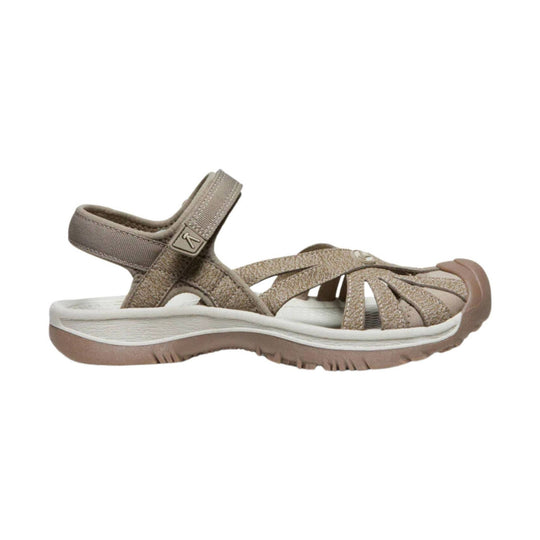 Taupe and brown women’s hiking sandal with a closed toe, crisscross straps, and an adjustable ankle strap