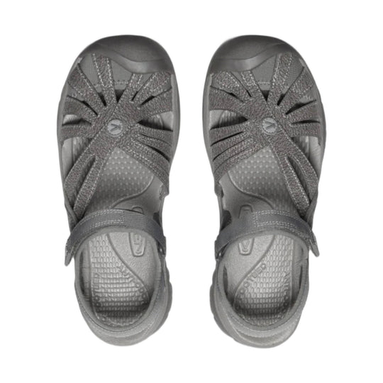Pair of gray closed-toe sandals with crisscross straps, bungee laces, and rubber toe caps, shown top view.