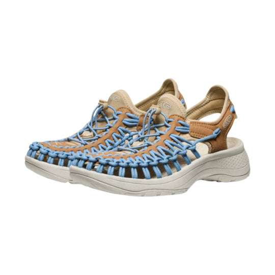 Tan closed-toe sandals with blue bungee laces and white soles