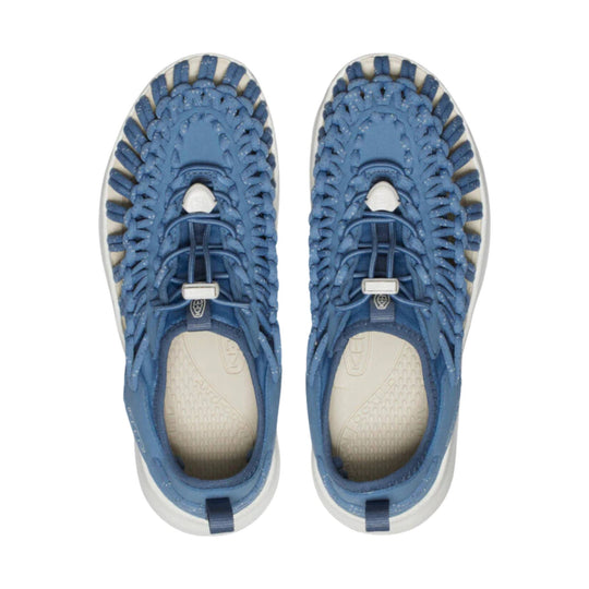 Blue woven closed-toe sandals with bungee laces and white soles, shown top view