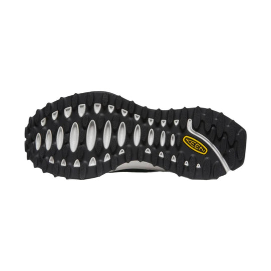 Black lugged boot outsole with white traction inserts and a yellow KEEN logo