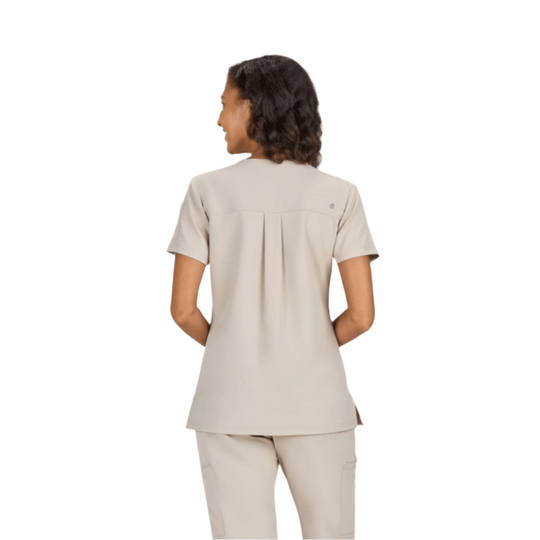 Beige short-sleeve scrub top shown from the back with a pleated yoke and side slits