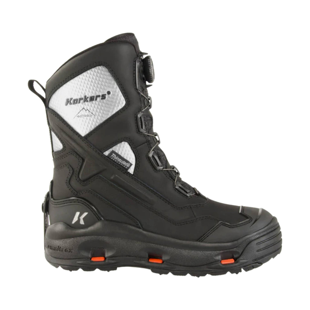 Black insulated winter boot with white side panels, lace-up front, and orange traction cleats in the sole
