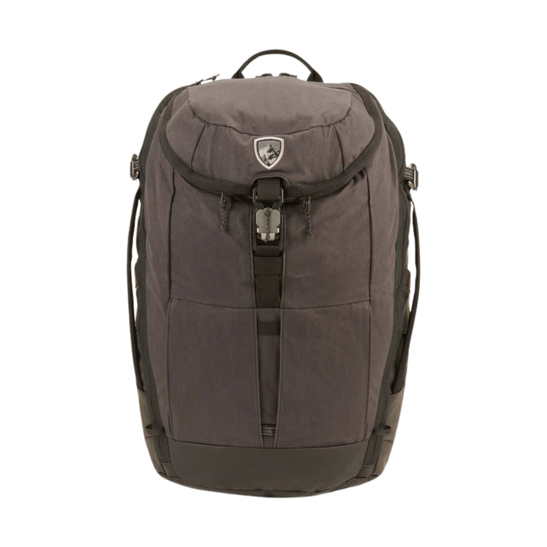 Brown backpack with a front flap buckle closure, top handle, and side compression straps
