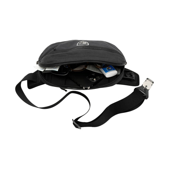Black sling pack with adjustable shoulder strap, open main compartment, and small logo on the front flap