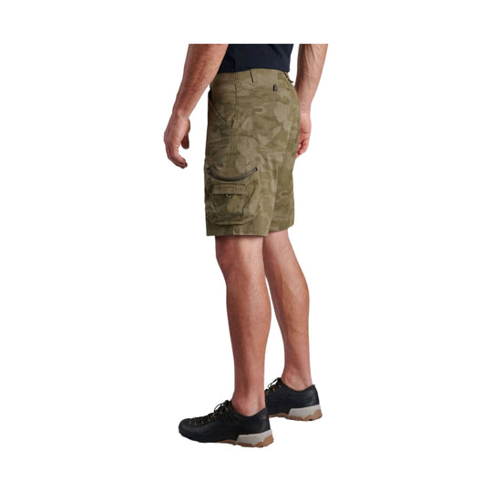 Olive camo cargo shorts with side cargo pockets, shown on a male model in side view