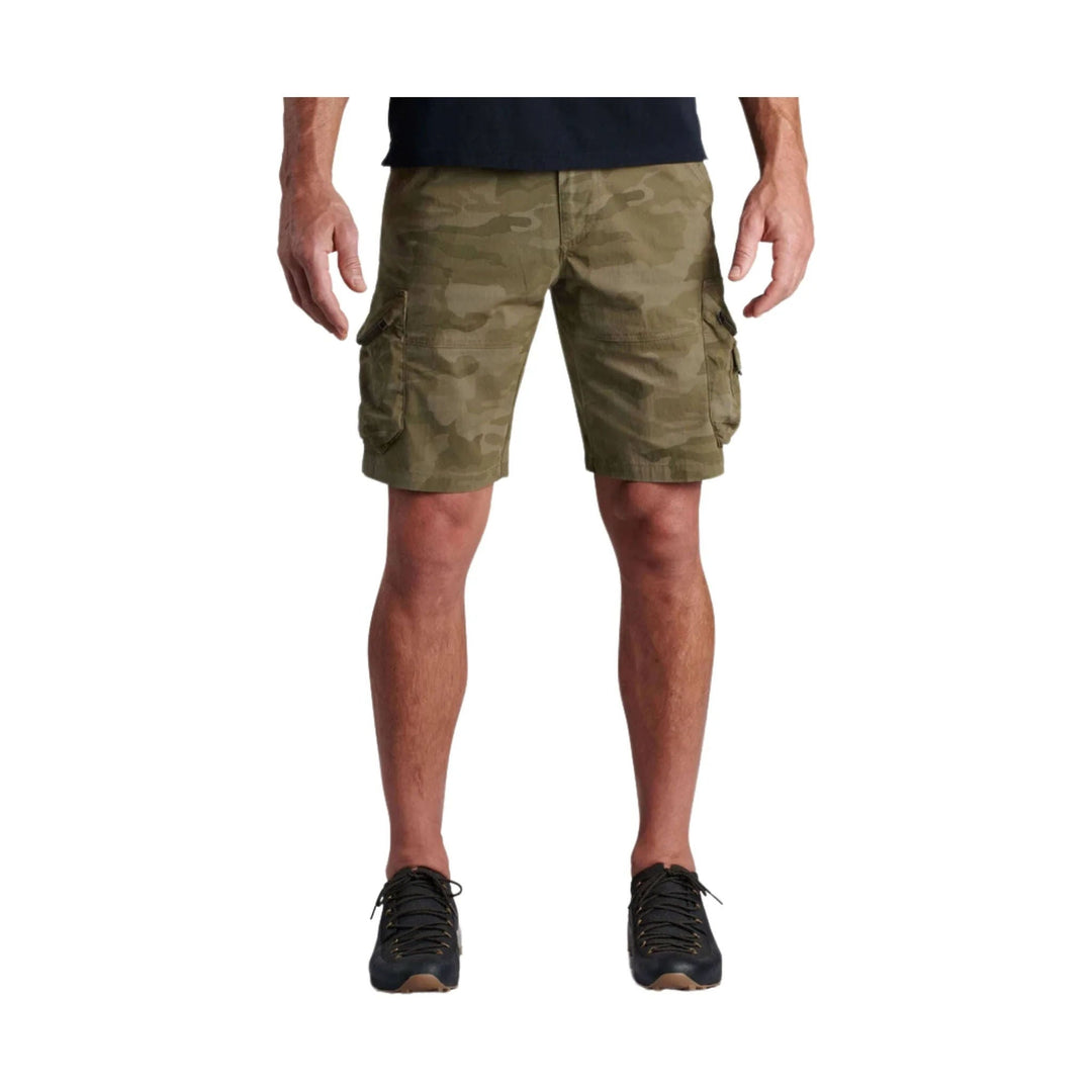 Olive camo cargo shorts with side flap pockets, shown on a model with black shoes
