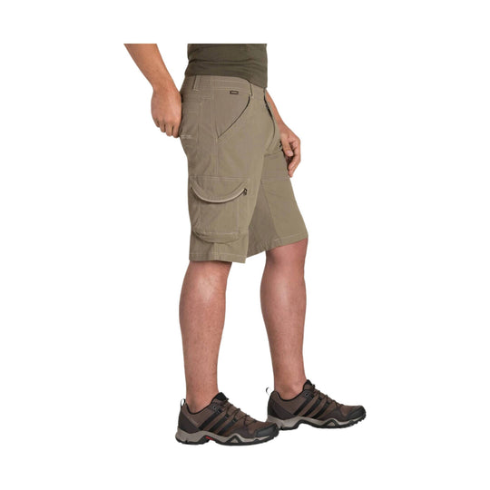 Khaki cargo shorts with side flap pockets, shown in side view on a model