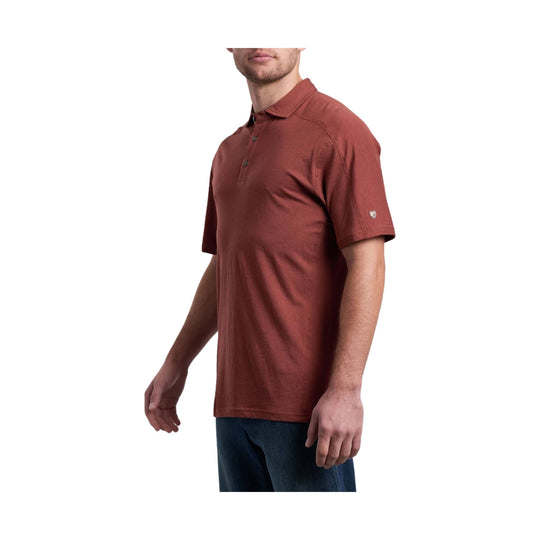 Rust-colored short-sleeve polo shirt with a collar and three-button placket, shown on a male model