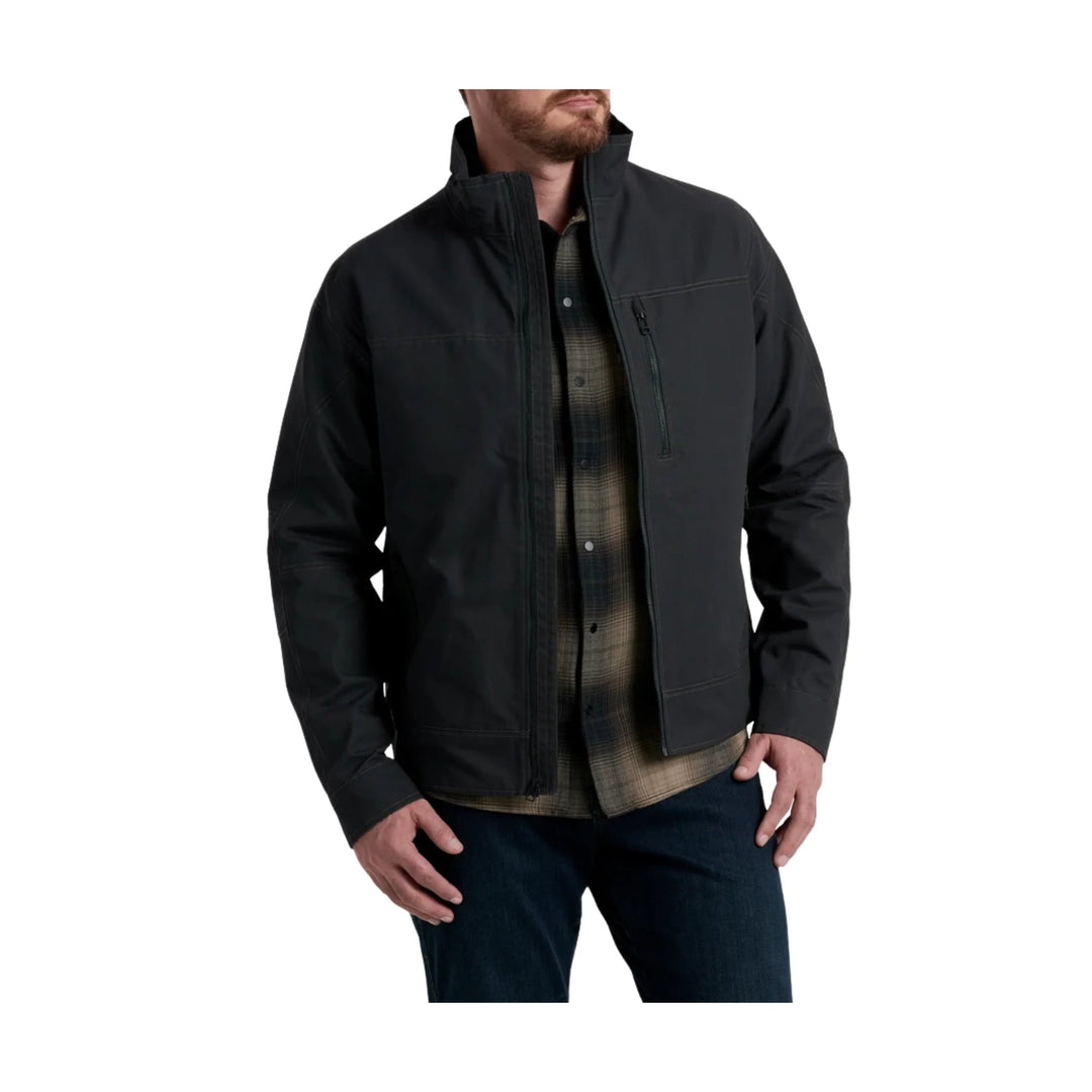 Black zip-front jacket with stand collar and chest pocket over a plaid shirt