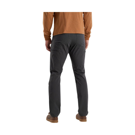 Back view of dark gray men’s hiking pants with zip pockets and straight legs