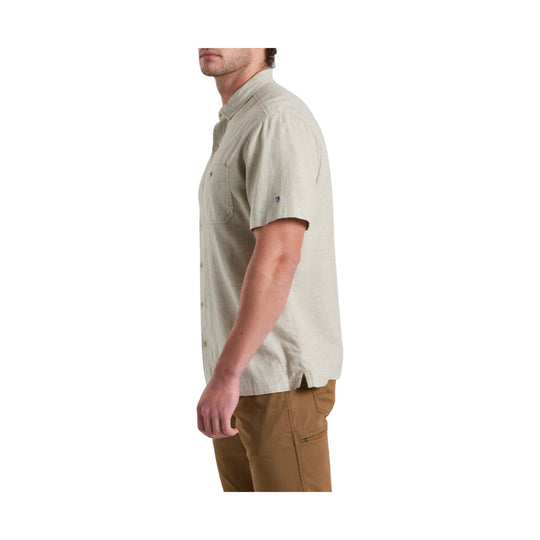 Light beige short-sleeve button-up shirt with chest pocket, shown in side view