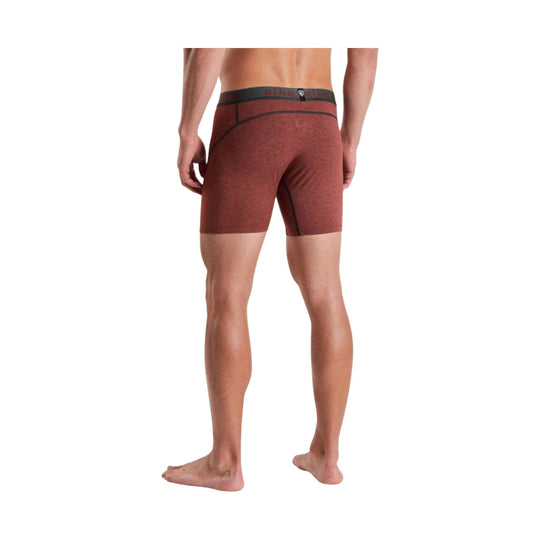 Rust-colored men’s boxer briefs shown from the back with black seam detailing and branded waistband