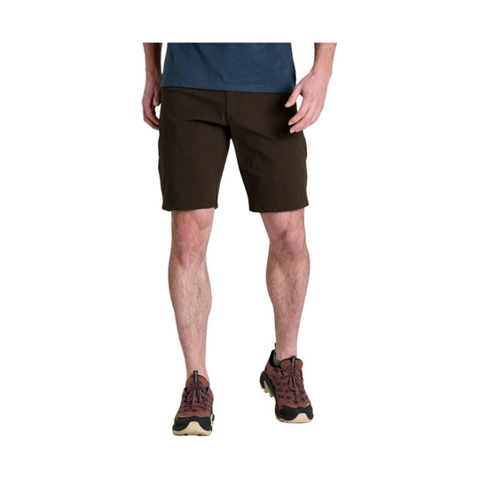Dark brown hiking shorts with a 10-inch inseam, shown on a model with trail shoes