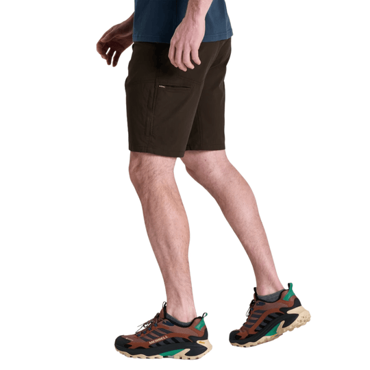 Dark brown cargo shorts on a model, shown with trail shoes