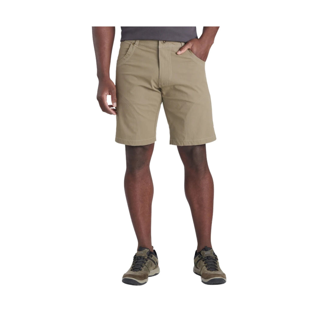 Khaki flat-front shorts with front pockets and belt loops, worn with hiking shoes