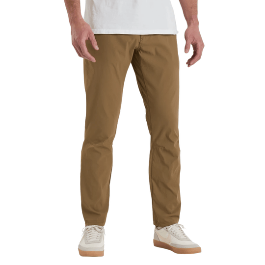 Tan straight-leg pants with a tapered fit, shown on a model with white sneakers