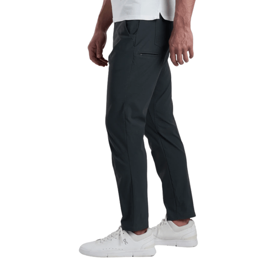 Charcoal gray men's pants with zippered thigh pocket, shown on a model with white sneakers.