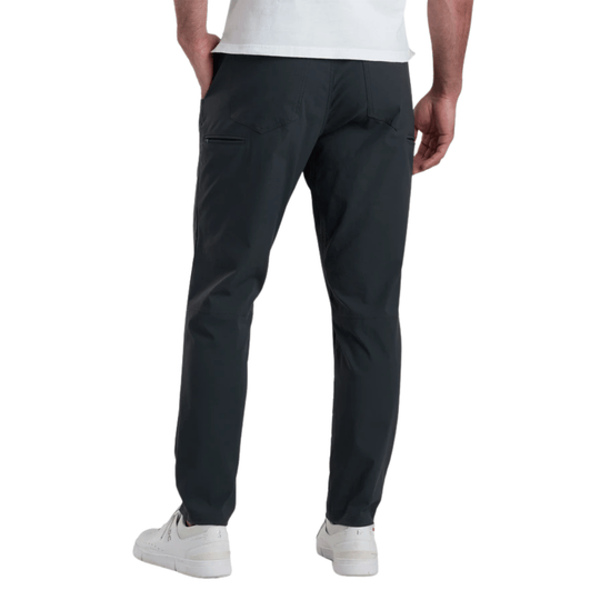 Men's dark charcoal pants shown from the back with tapered legs and a zip pocket on the thigh