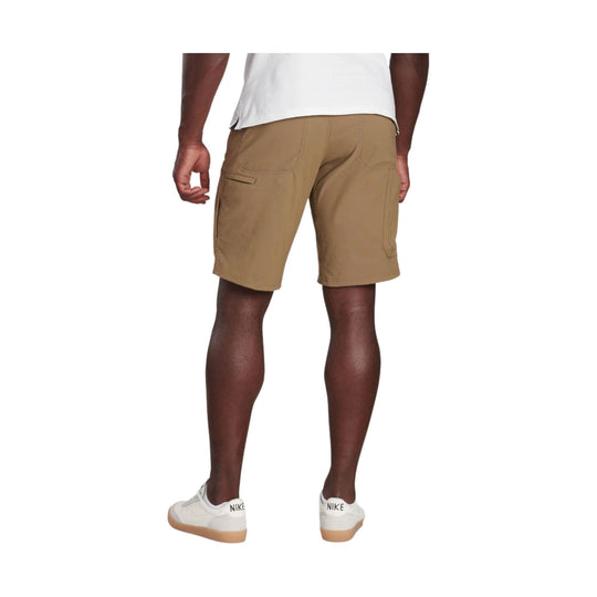 Tan cargo shorts shown from the back with side pockets, worn with white Nike sneakers
