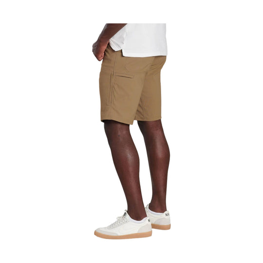 Tan cargo shorts worn with a white T-shirt and white sneakers, shown in side view