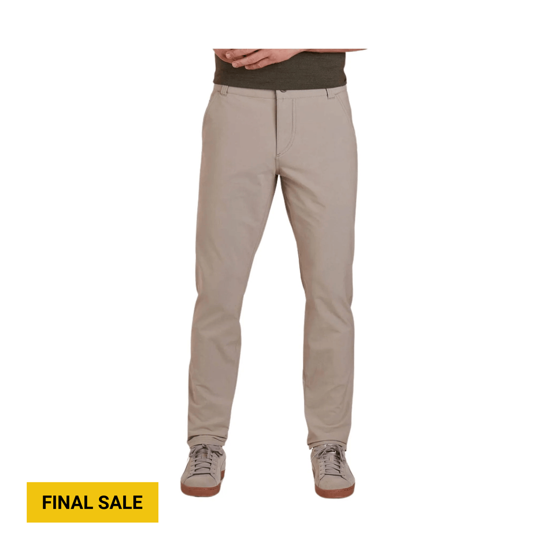 Khaki tapered pants with front pockets and sneakers, shown on a model against a white background.