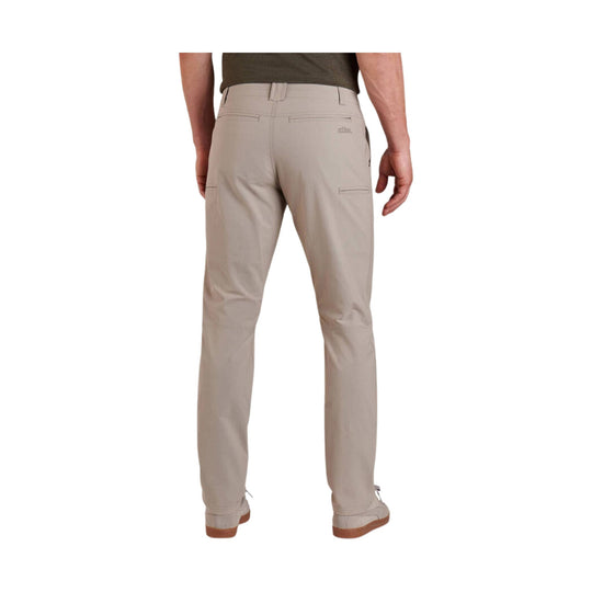 Khaki tapered pants shown from the back