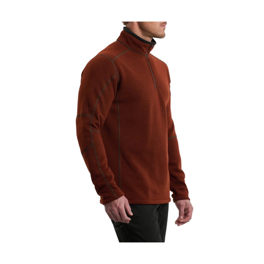 Rust-colored quarter-zip pullover with contrast seam stitching and long sleeves