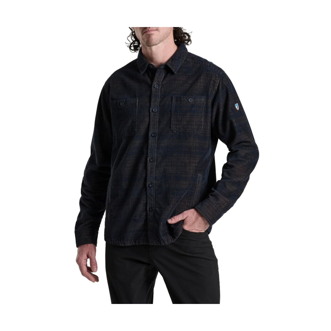 Black long-sleeve corduroy button-up shirt with two chest pockets and a small sleeve patch