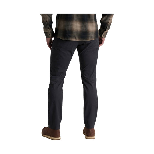 Men's dark gray straight-leg pants shown from the back with rear pockets and brown shoes